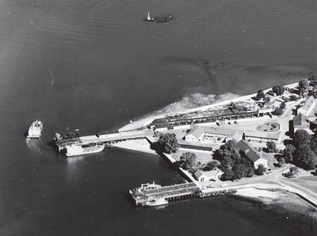 <p>Aerial view of the Freight Pier (upper) and Passenger Dock (lower) on the shore of Fort Slocum&#39;s Quartermaster Area, looking north, late 1950s.</p>