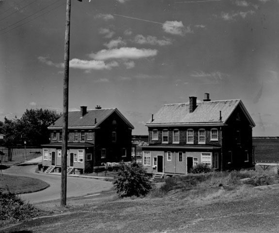 <p>Buildings 101 and 102, two of the two-family houses (duplexes) for NCOs, view northeast, 1958.</p>