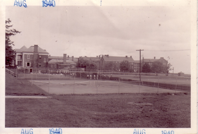 <p>Enlisted Men&#39;s Tennis Courts on the western edge of the Drill and Athletic Field, looking north-northeast, 1940. Behind, left to right, are the YMCA (Building 71) and two barracks, Buildings 61 and 60.</p>