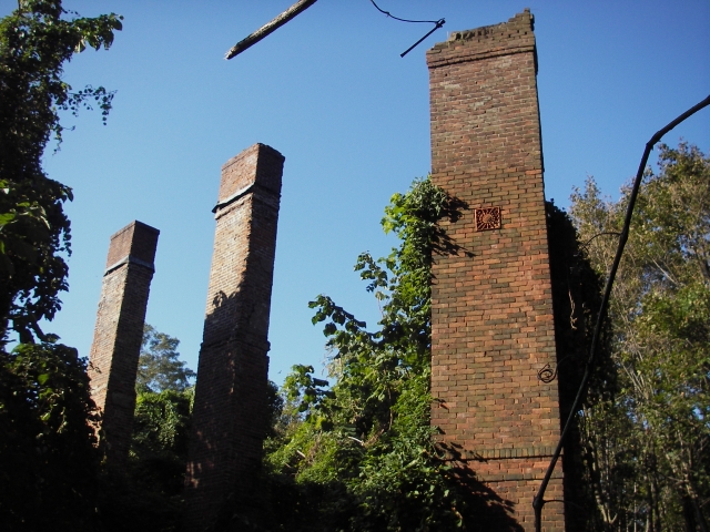 <p><strong>Queen Anne, detail</strong>: Brick chimneys with decorative terra cotta plaque (center of right chimney). Ruins of Officers&#39; Quarters (Building 5), view southwest, October 2006.</p>