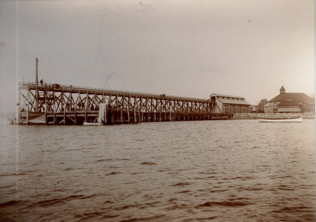 <p>From 1893 until 1932, a wood trestle for unloading coal barges dominated the Freight Pier, also called the Coal Dock. View to northeast, ca. 1893.</p>