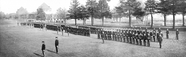 <p>Dress parade, a ceremony in which soldiers wear full, formal uniforms and carry arms. Southern end of the Parade Ground, looking north-northeast, November 1904.</p>