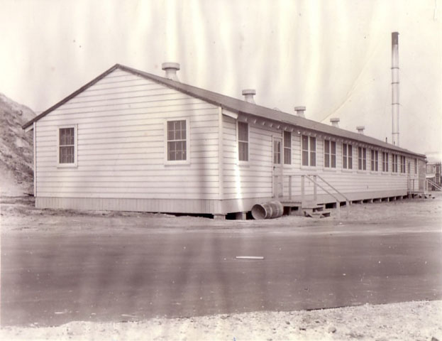 <p>Building T-117 was one of several semi-permanent &#34;temporary&#34; buildings erected during the Second World. At different times, it served as storehouse, office and NCO club. View north, 1942.</p>