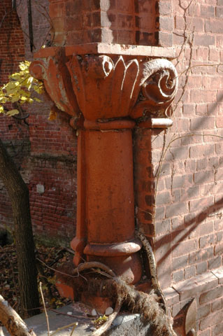 <p><strong>Romanesque Revival, detail</strong>: Terra cotta engaged dwarf column with foliate capital. Entrance to Barracks (Building 69) tower, view east-northeast, December 2005.</p>