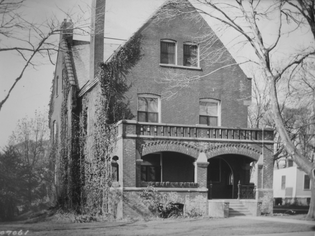 <p><strong>Romanesque Revival</strong>: Commanding Officer&#39;s Quarters (Building 1), east facade with brick porch (added before 1915), view west, ca. 1935.</p>