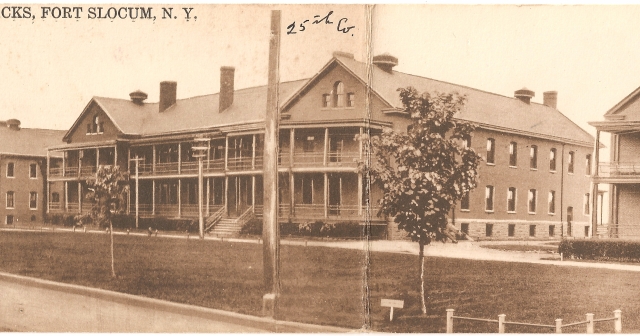 <p><strong>Colonial Revival</strong>: Early example of the style. Barracks (Building 63), built 1906, west facade with original wood porch, shown in view to northeast, ca. 1914.</p>