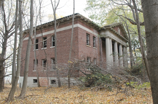 <p><strong>Neoclassical, details</strong>: Formal symmetry and projecting center pavilion with full-height porch. Administration Building (Building 13), view northwest, November 2005.</p>