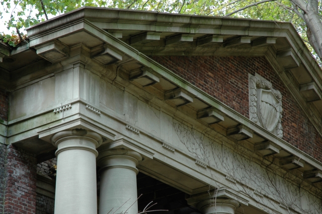 <p><strong>Neoclassical, details</strong>: Doric pediment, entablature, and capitals reflect Classical precedents in the design of the center pavilion of the Administration Building (Building 13). East facade, view northwest, November 2005.</p>