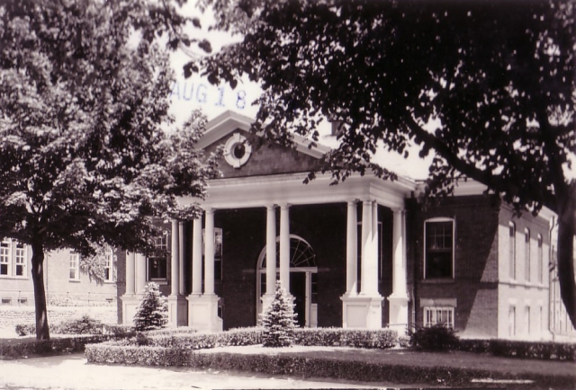 <p><strong>Neoclassical</strong>: Post Exchange (Building 70; built 1905), west facade with portico, view east-northeast, ca. 1939.</p>