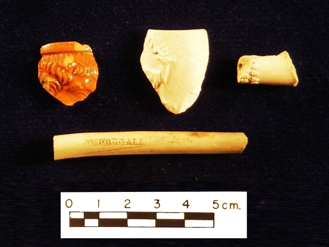 <p>Examples of fragments of 19th-century smoking pipes recovered during the 2005-2006 archeological survey of Davids Island, including pieces of pipe bowls and stems with cast decorations (top row) and an unglazed kaolin pipestem stamped &#34;McDougall&#34;, a manufacturer who was located in Glasgow, Scotland (bottom).</p>
