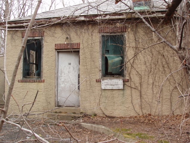 <p>Building number on door beside department identification sign, south side of Paint Shop (Building 32), looking north, March 2006.</p>
