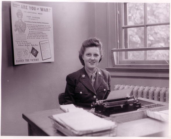 <p>WAC typist with Fort Slocum recruitment drive poster, 1944.</p>