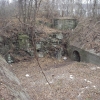 <p>Exposed bedrock, which forms southern wall of Battery Haskin Pit A (Building 125), looking southwest, December 2008.</p>