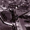 <p>Aerial view of a portion of the Quartermaster Area and adjoining areas, looking northeast, taken in November 1961. The Coal Yard (Building 27A)&#160; and part of the conveyor system is in the left foreground, and the Garage (Building 40) is in the right foreground. The small, 1950s-era trailer park at Fort Slocum can be seen to the left of the Coal Yard.</p>
