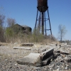 <p>Fort Slocum&#39;s Watertower (Building 45), the neighboring Non-Commissioned Officers&#39; Quarters (Building 44), and the adjoining shoreline with scattered ruins of Parker Road, looking west, April 2006.</p>
