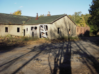 A portion of the Quartermaster Area, showing the Garage (Building 40, left) and the Carpenter Shop (Building 24, right rear), view to northeast, October 2006.