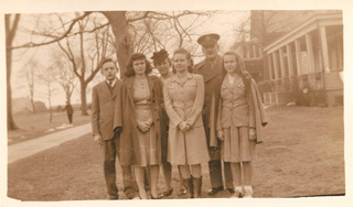 Chaplain Maj. Wesley Gebhard and his family outside their quarters (Building 3) on Officers' Row, ca. 1944