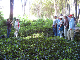 Group tour of Davids Island posing near the Commanding Officer's Quarters (Building 1), September 2007. At left are Nancy Brighton (with camera) and Barbara Davis. The group includes: Harold Crocker, George Willhite, Susan Edwards, Bill Carlson, and Pat Skelly (left-right, front); John Pardon, Joel Simons, and Bill Waterhouse (left-right, back)
