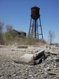 Fort Slocum's Watertower (Building 45), the neighboring Non-Commissioned Officers' Quarters (Building 44), and the adjoining shoreline with scattered ruins of Parker Road, looking west, April 2006.